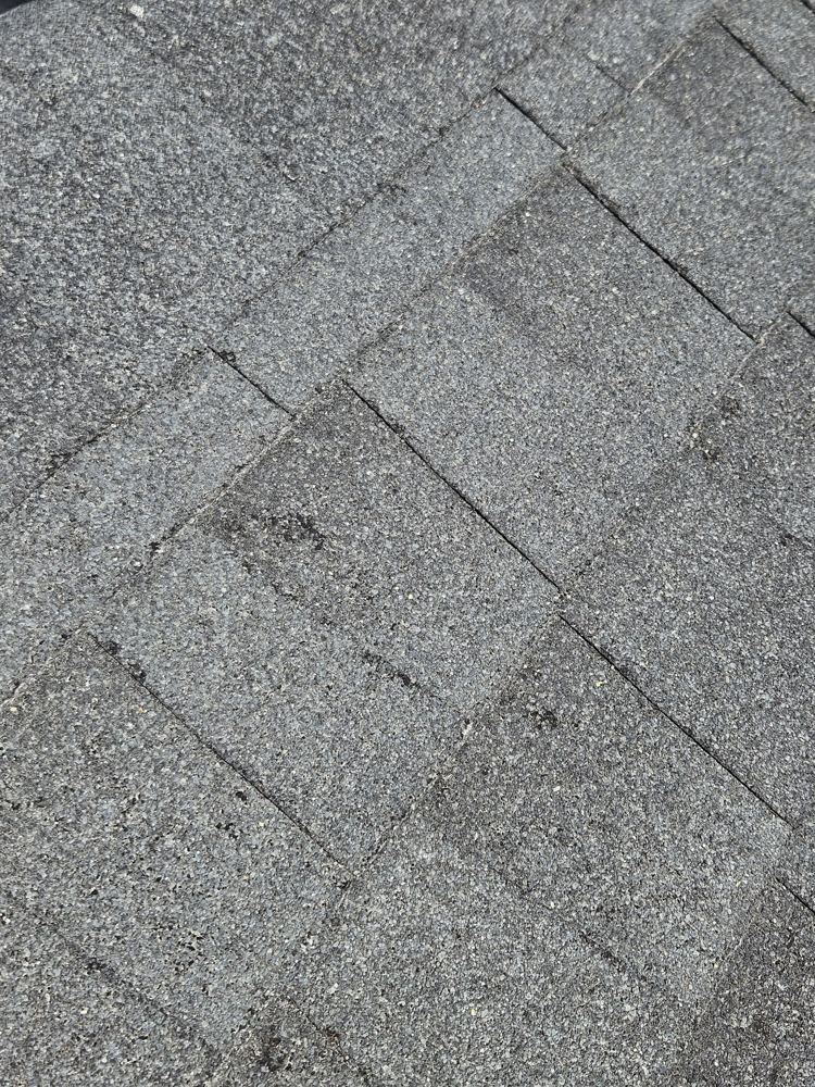 Additional hail impact marks on roof shingles